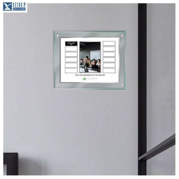 Monthly recognition plaque with engraved silver text on wall