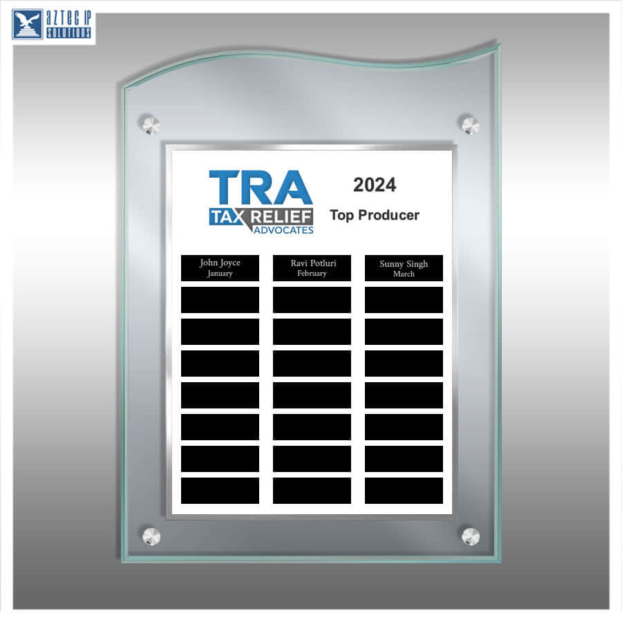 A custom acrylic and glass wall plaque with a silver metallic frame, featuring a customizable white board with black name blocks and the text '2024 TAX RELIEF Advocates Top Producer'.
