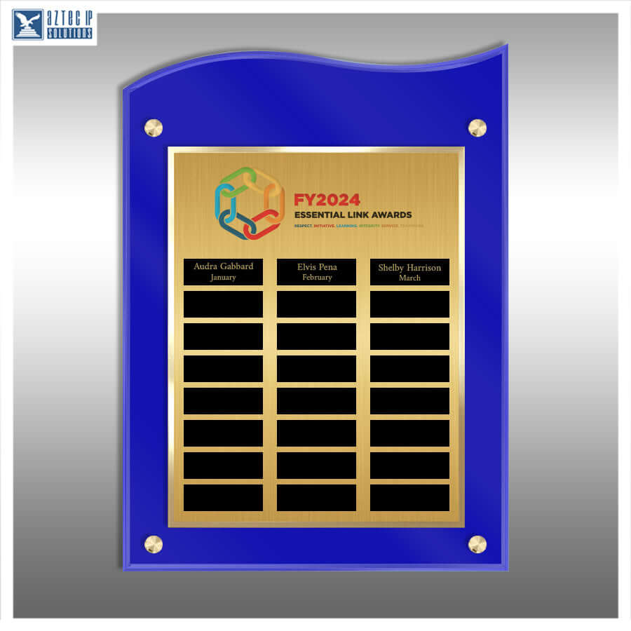 A custom acrylic and brass name plaque with a royal blue border and a gold-toned central panel. The panel features the 'FY2024 Essential Link Awards' logo and three black nameplates with gold text, mounted on a gray gradient background.