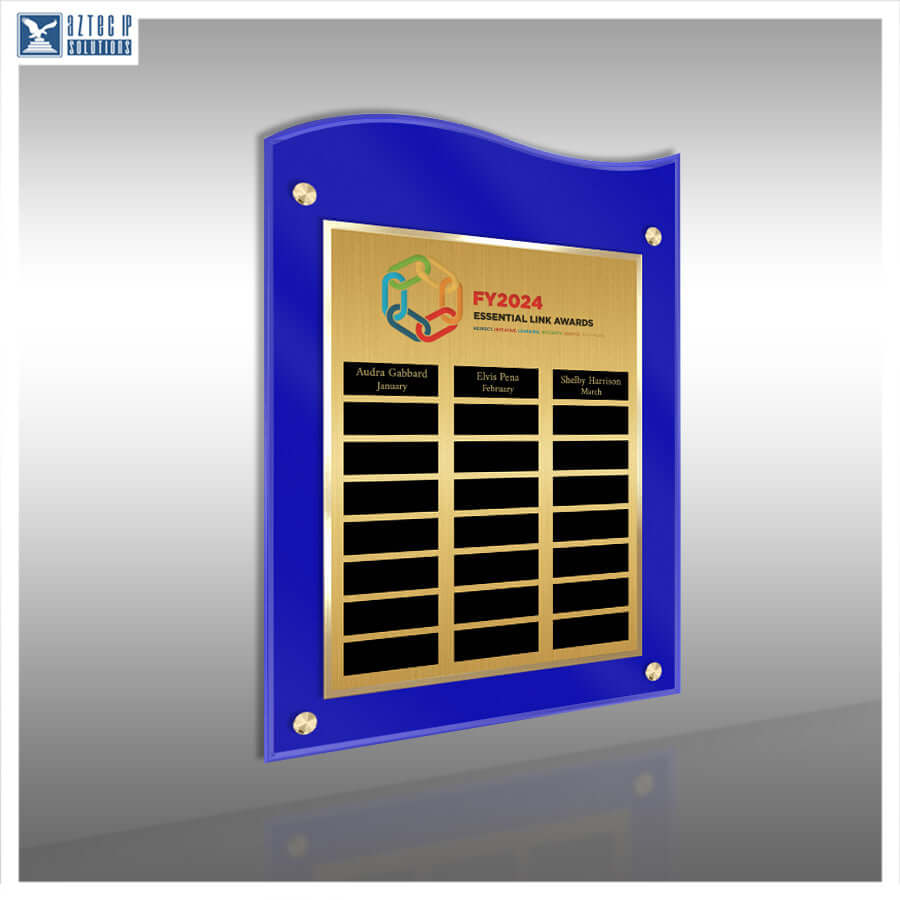 A custom acrylic and metal award plaque on a gray gradient background. The plaque features a vibrant blue acrylic frame with a wavy top edge, four gold screws, and a central gold-colored metal plate engraved with the 'FY2024 ESSENTIAL LINE AWARD' logo and black name slots.