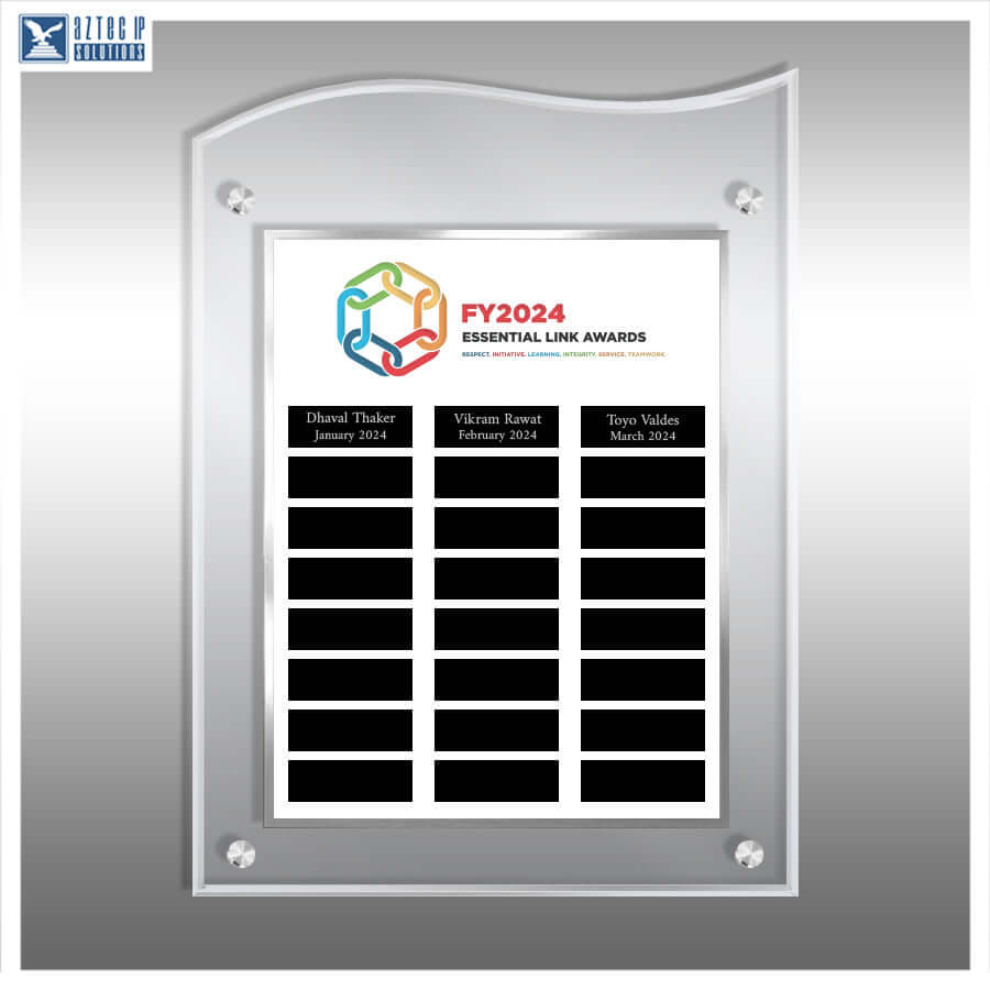 A custom acrylic wall plaque with a silver frame, featuring a white insert printed with the 'FY2024 Essential Link Awards' logo and three black name slots. The plaque is shown mounted on a metallic gray wall, with a 'HITOCHIP SOLUTIONS' logo in the top-left corner.
