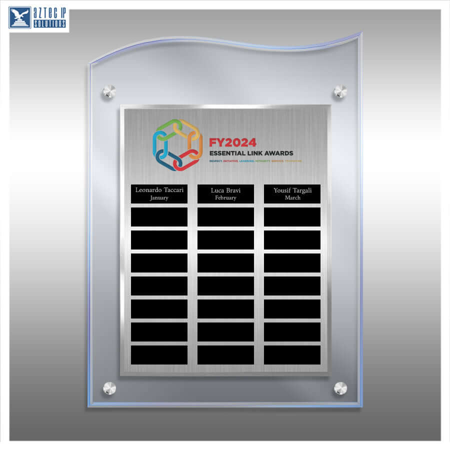 A custom acrylic and brushed metal award plaque on a gray gradient background. The plaque features a brushed silver center panel with black nameplates for 'Leonardo Tencot January', 'Lara Berriz February', and 'Youssef Targhi March', under the 'FY2024 ESSENTIAL LINK AWARDS' logo.