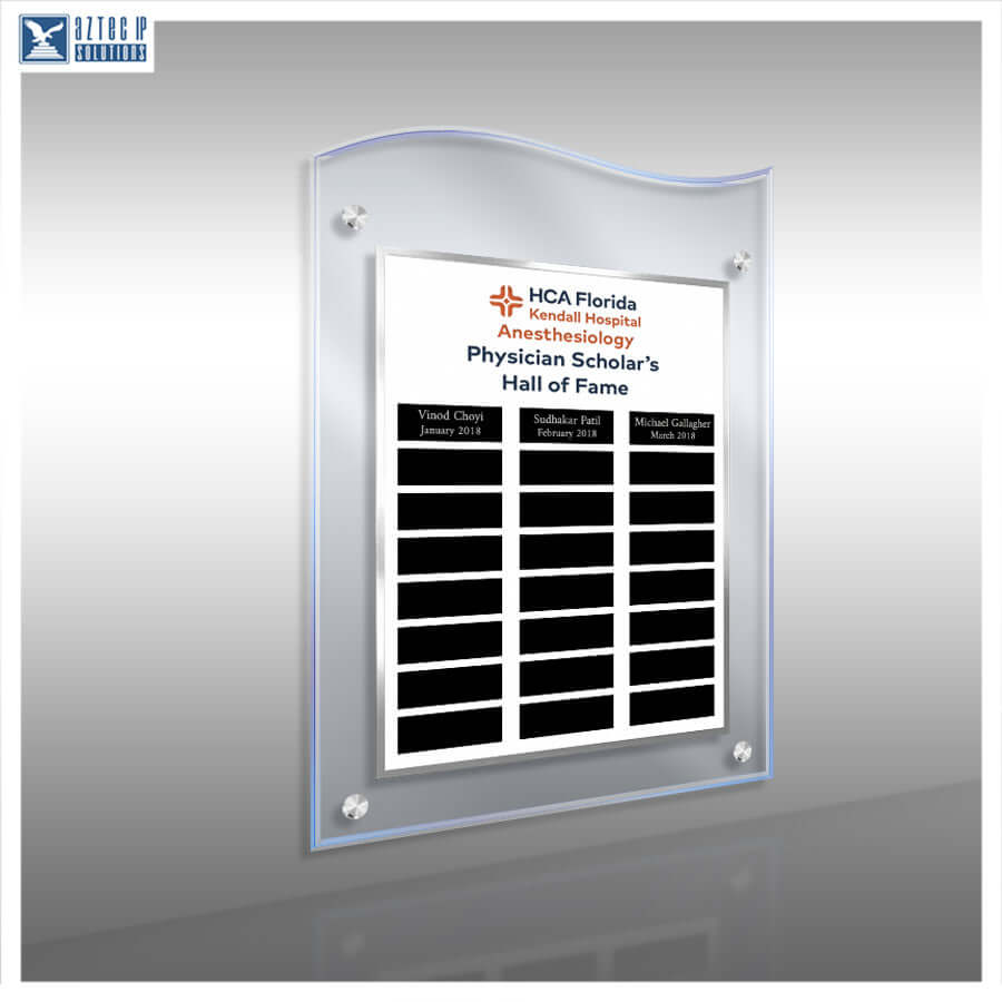 A custom acrylic wall plaque with a wavy top edge, featuring a white insert printed with the HCA Florida Kendall Hospital Anesthesia Physician Scholar's Hall of Fame text and three black nameplates, shown on a gray gradient background.