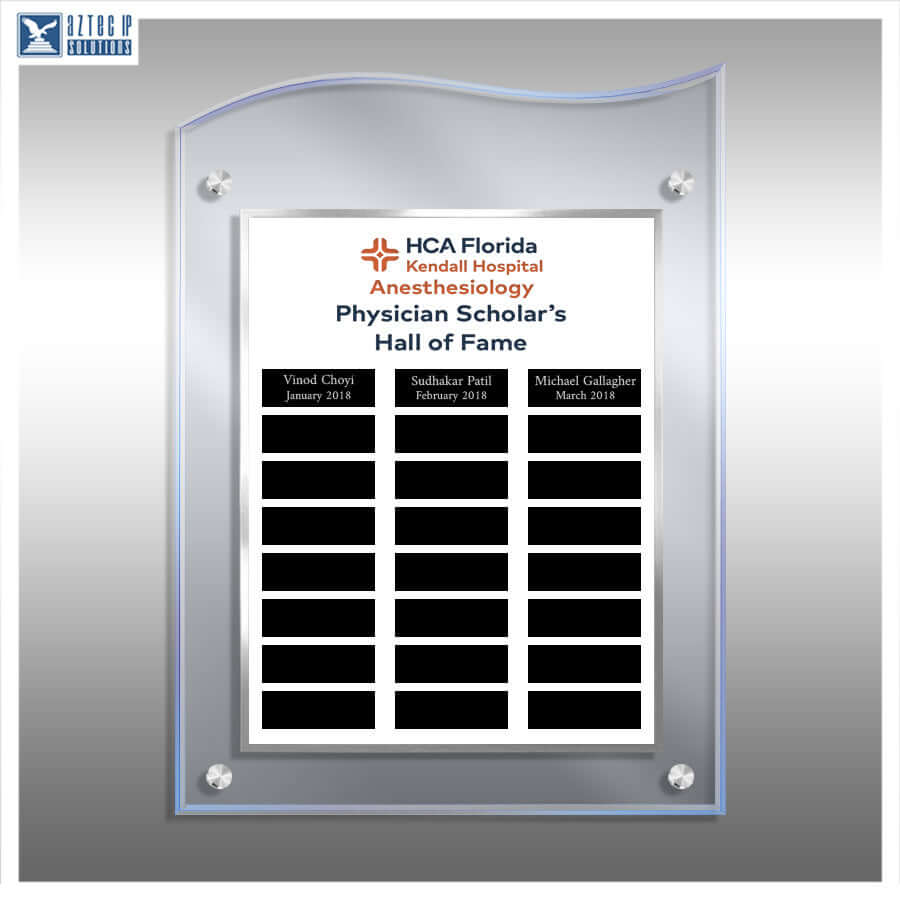 A custom acrylic and glass wall plaque with a curved top, mounted on a gray gradient background. The plaque features a white insert printed with the 'HCA Florida Kendall Hospital Anesthesiology Physician Scholar's Hall of Fame' logo and three black nameplates at the bottom.
